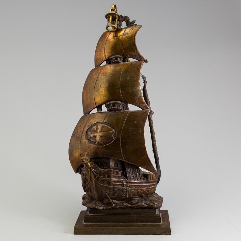 A set of three, early 20th century, bronze fire irons together with a stand, Nestor, England.