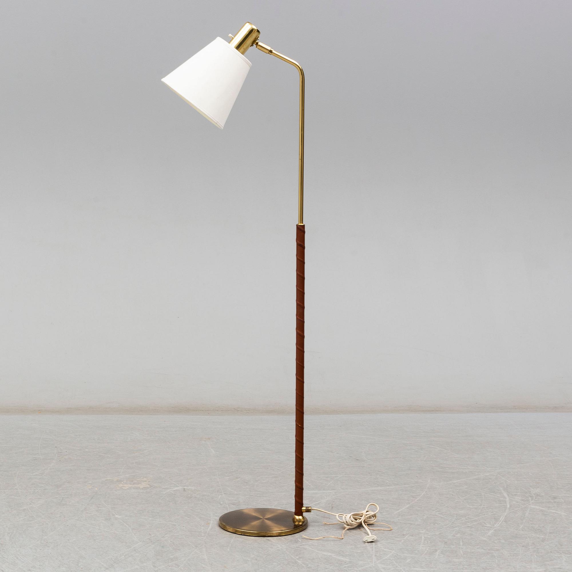 a brass and leather floor lamp from the second half of the 20th century.