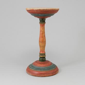 A painted wooden butter stand from the 19th century.