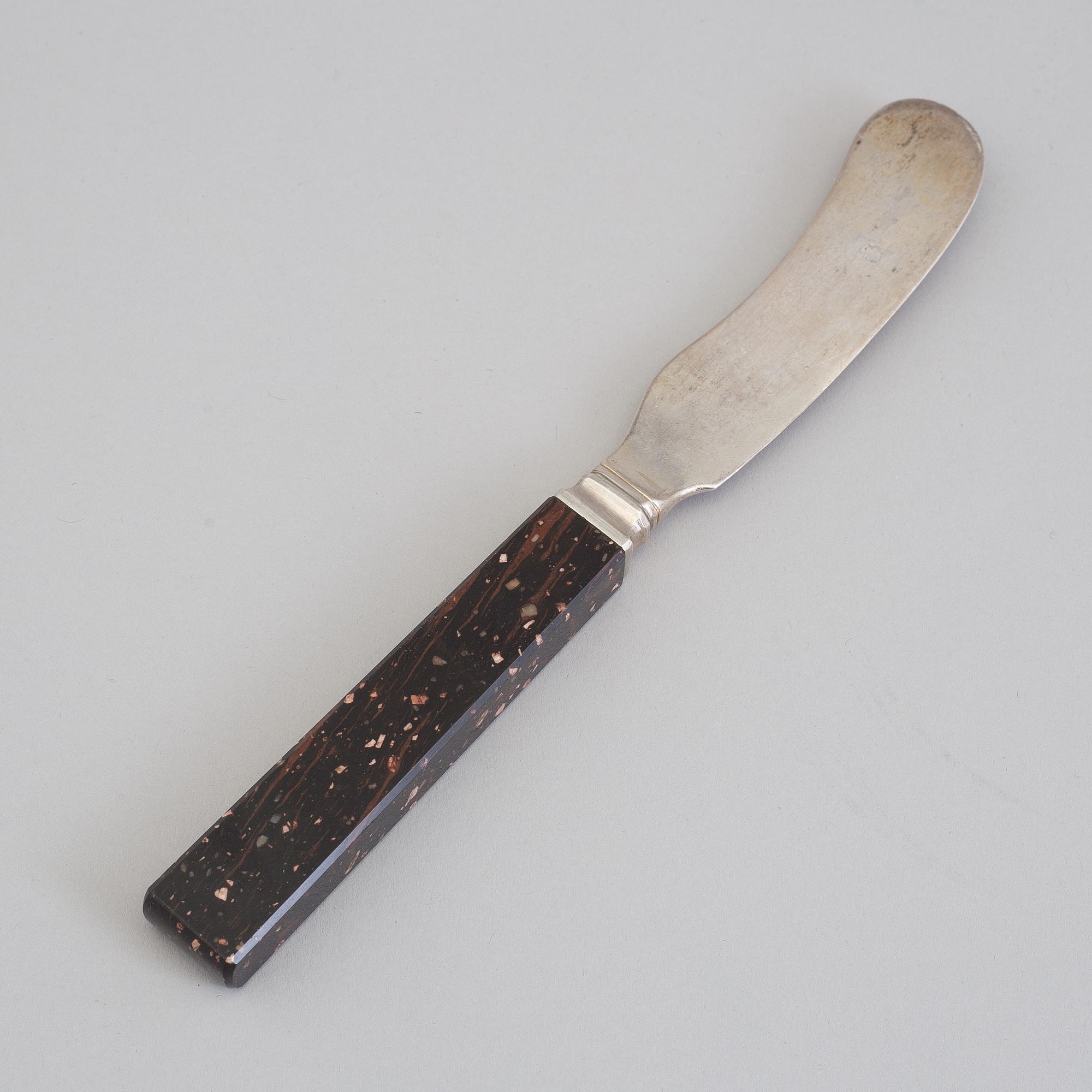 A silver butterknife with porphyry shaft, dated 1853.