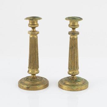 A pair of Empire bronze candlesticks, first half of the 19th Century.