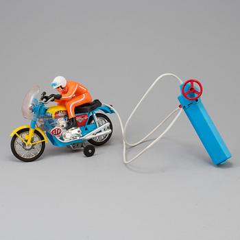 A 1970s battery operated toy racing auto cycle,Original "Junior" Product, Japan.