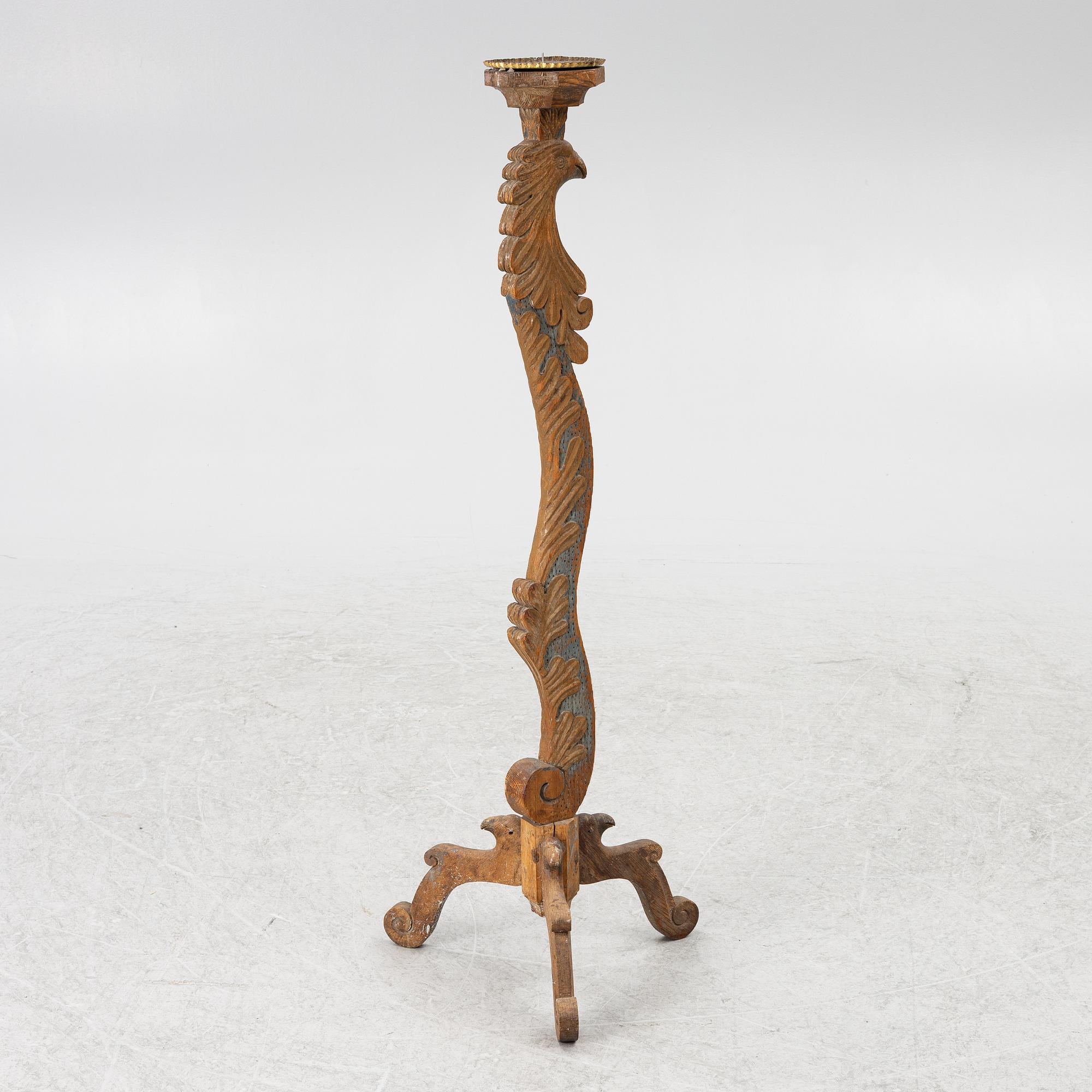A carved wood floor candlestick, circa 1900 composed of 18th century elements.