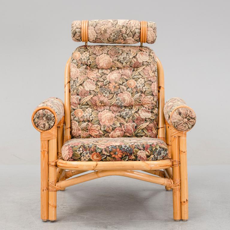 A set of two garden sofas, an armchair and a glass table, later part of the 20th Century.