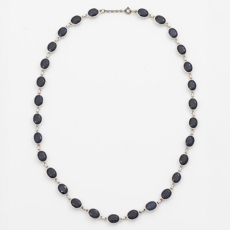 18K white gold necklace with dark sapphires.