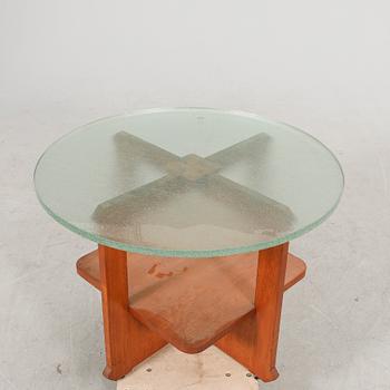 A 1940s wood and glass coffee table.