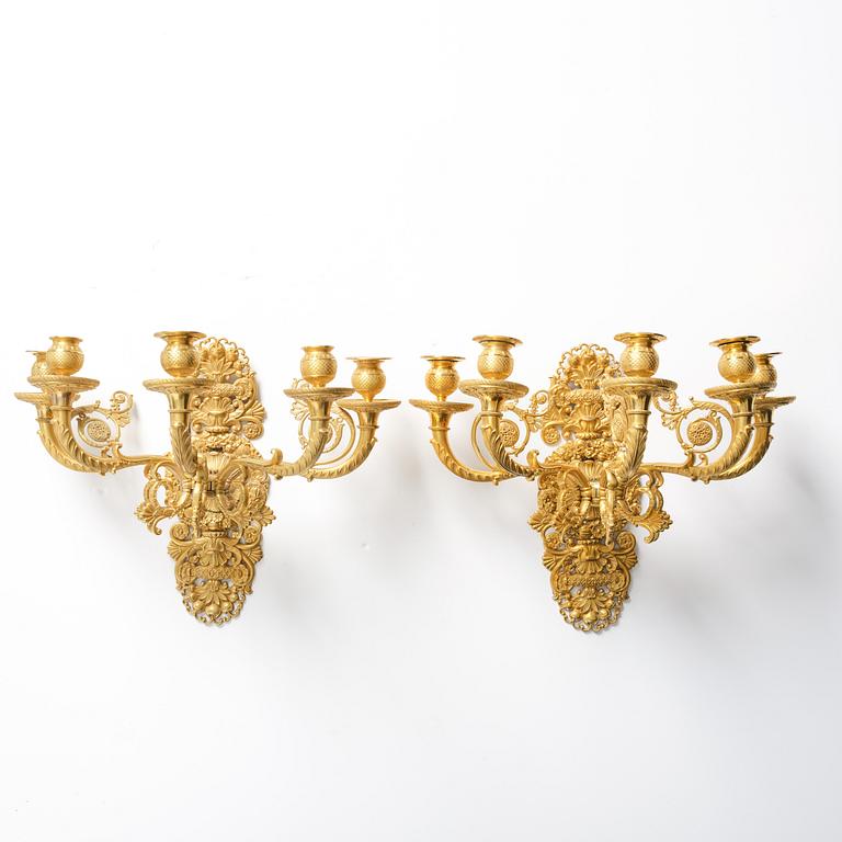 A pair of French Empire ormolu five-branch wall-lights, Paris, early 19th century.