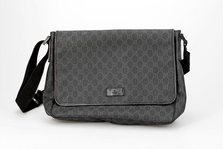 A black monogram canvas bag by Gucci.