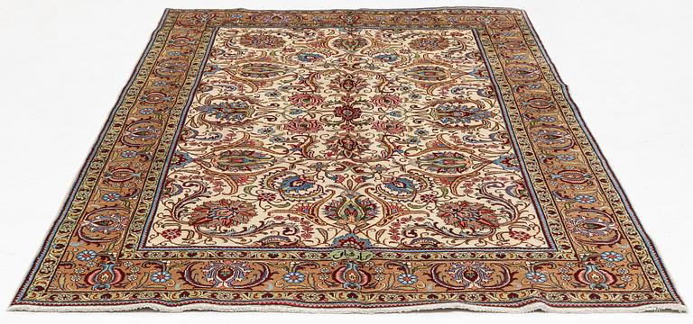 A signed Tabriz carpet, c 309 x 205 cm.