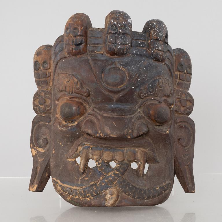 Four Tibetan/South East Asian wooden decorations, 20th century.