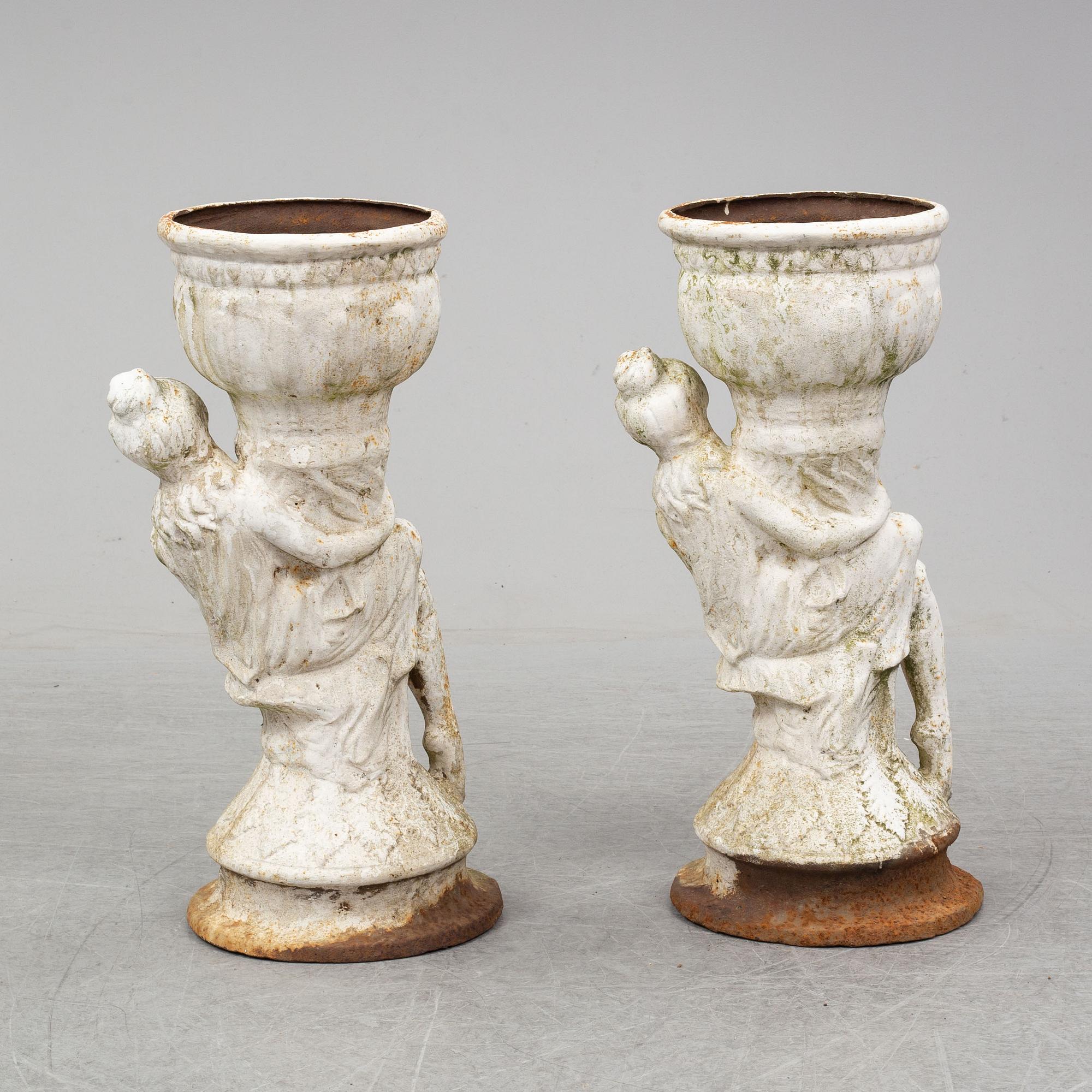 An end of the 20th Century pair of cast  iron flower pots.