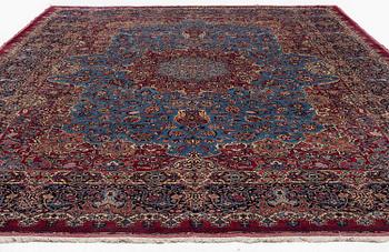 A Mashad carpet, signed Saber, c. 468 x 248 cm.