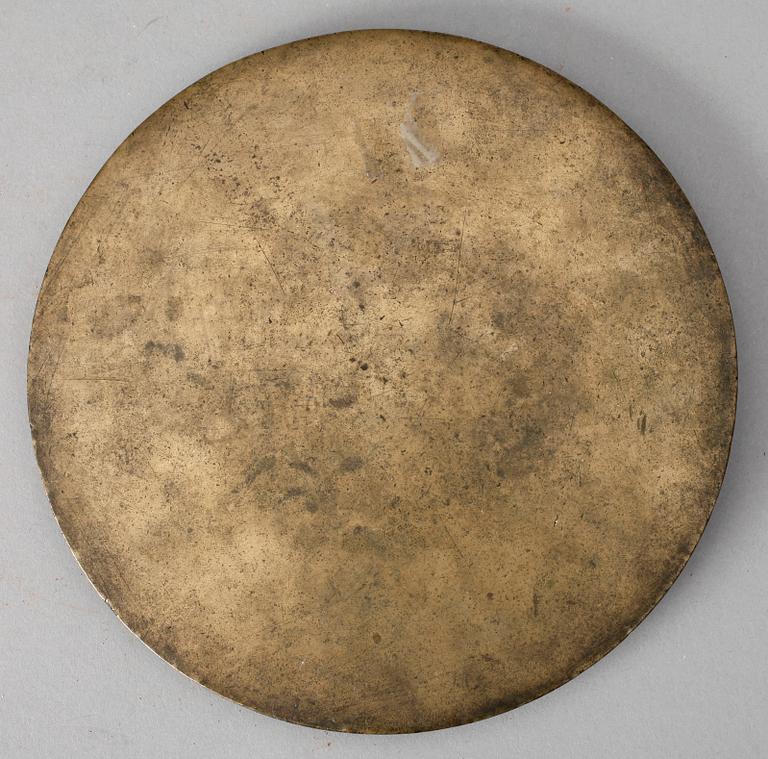 A bronze mirror, presumably Ming dynasty or older.