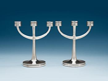 756. A pair of Erik Löfman silver candelabra, MGAB, Uppsala 1975.