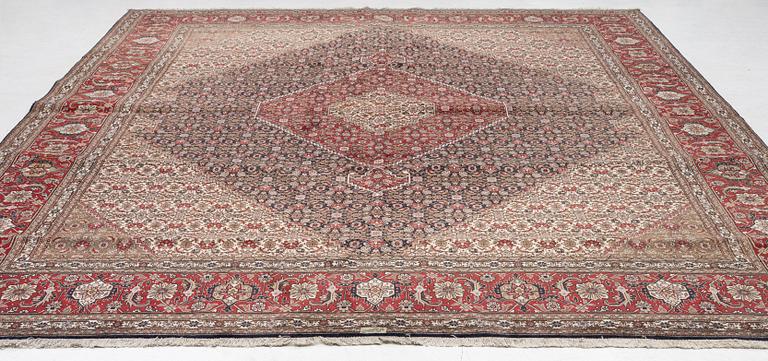 A signed Tabriz carpet, c. 385 x 300 cm.