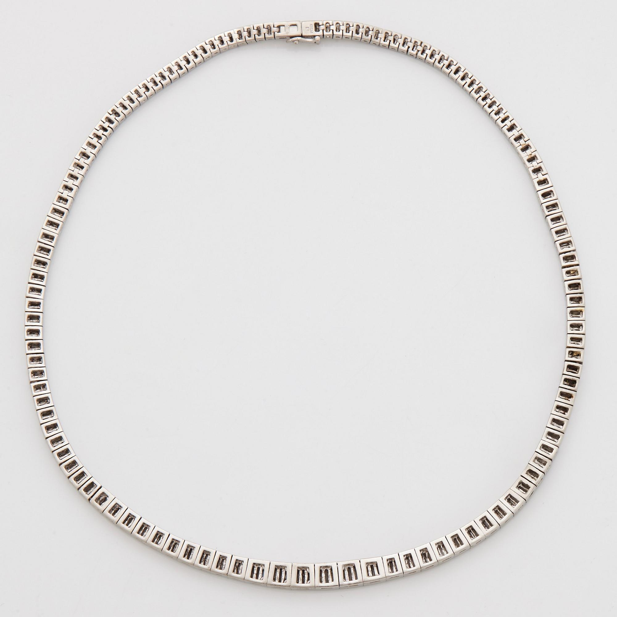 A platinum necklace set with tapered baguette-cut diamonds.