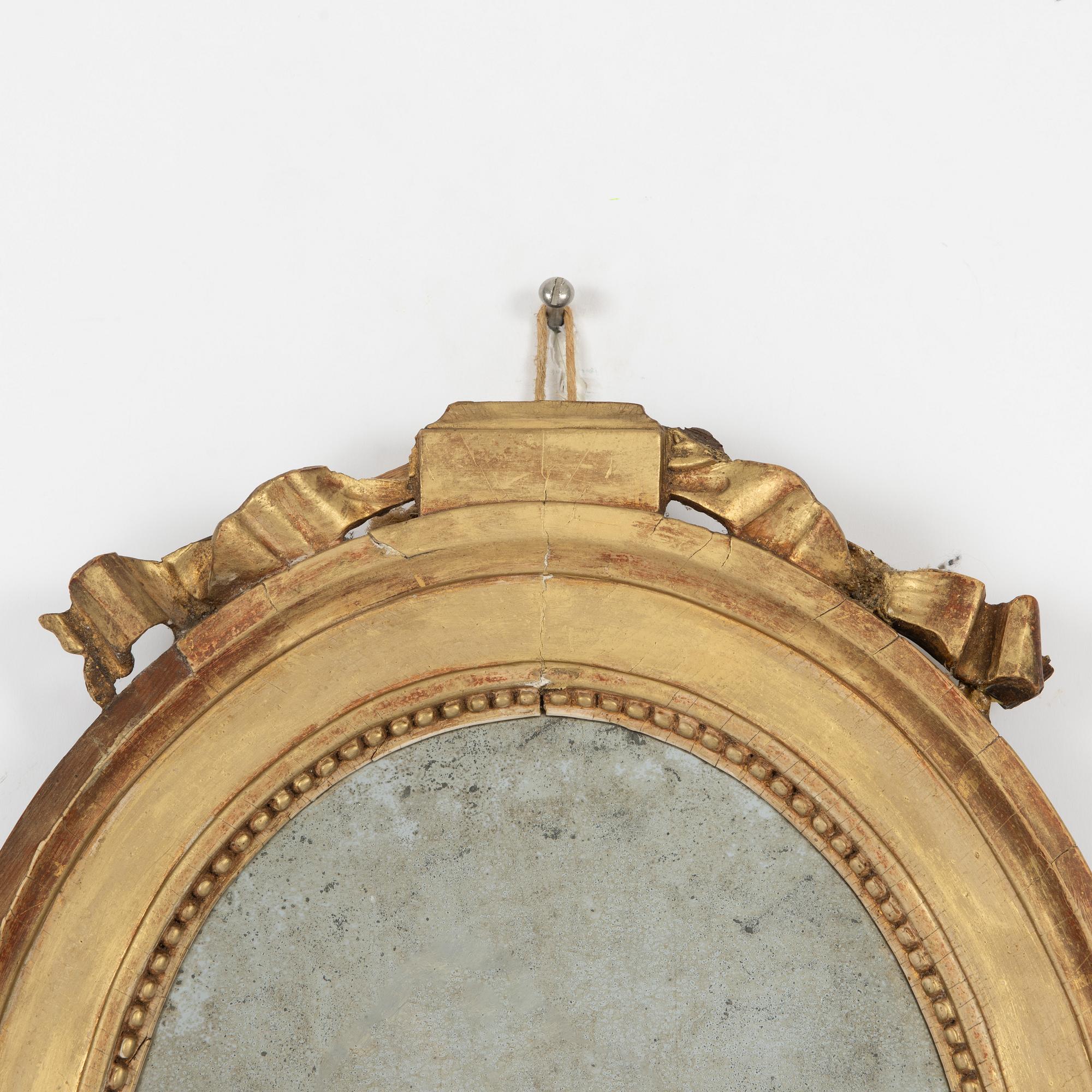 A Gustavian giltwood two-branch girandole mirror, late 18th century.