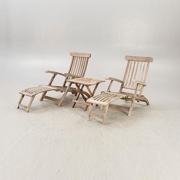 A pair of teak deck chairs and table later part of the 20th century.