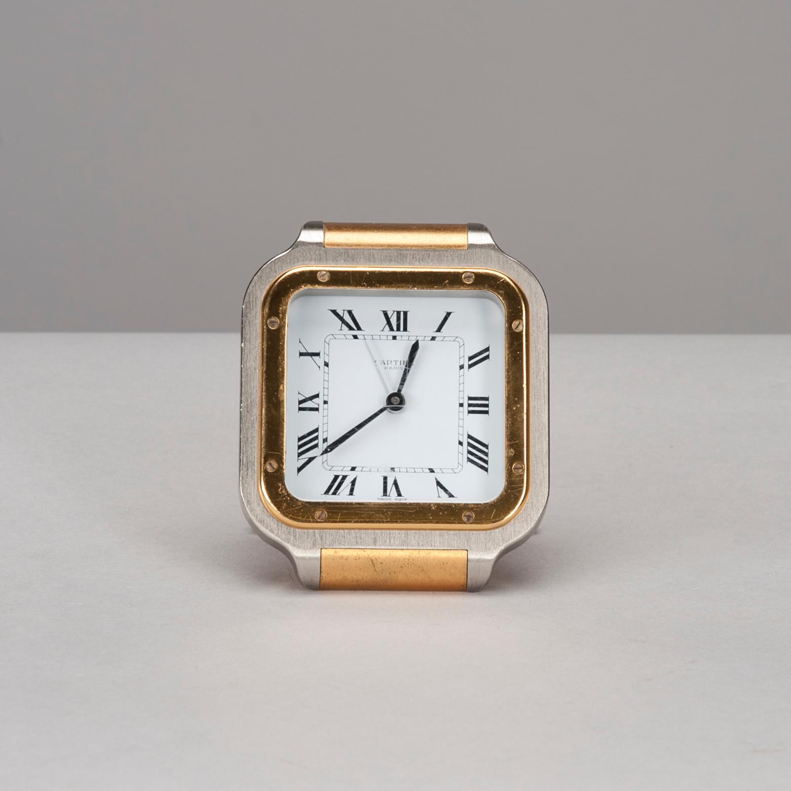 A CARTIER TABLE CLOCK, steel with gidt decoration, late 20th century.