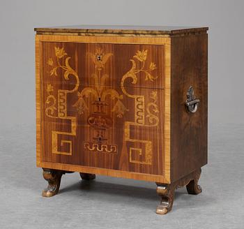 A 1920's, probably Swedish, chest of drawers with inalys of serveral woods and silverplated metal handles.