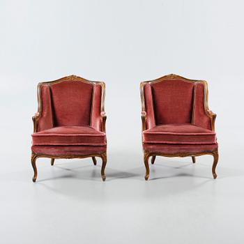 A pair of 20th century rococo revival armchairs.