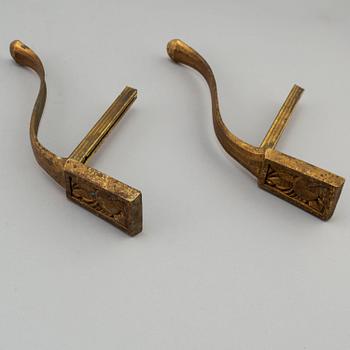 Three pairs of bronze and brass tie-backs, 19th century.