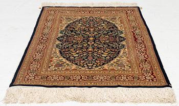 A Hereke silk rug, c. 130 x 71 cm.