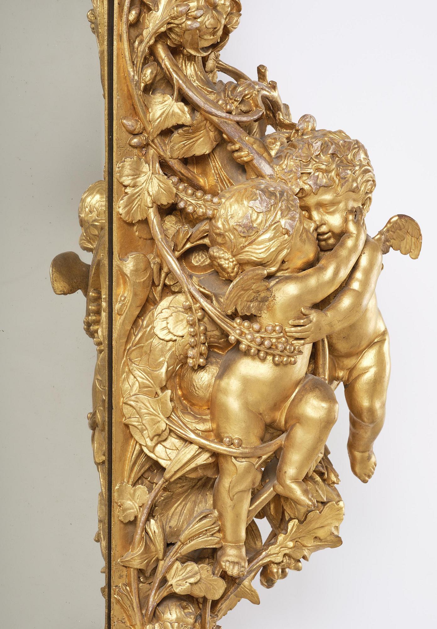 A presumably Dutch Louis XIV carved giltwood frame with mirror glass, in the style of Jean Le Pautre, late 17th century.