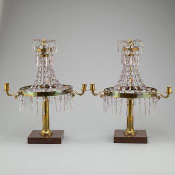 A pair of late Gustavian style three-light candelabra.