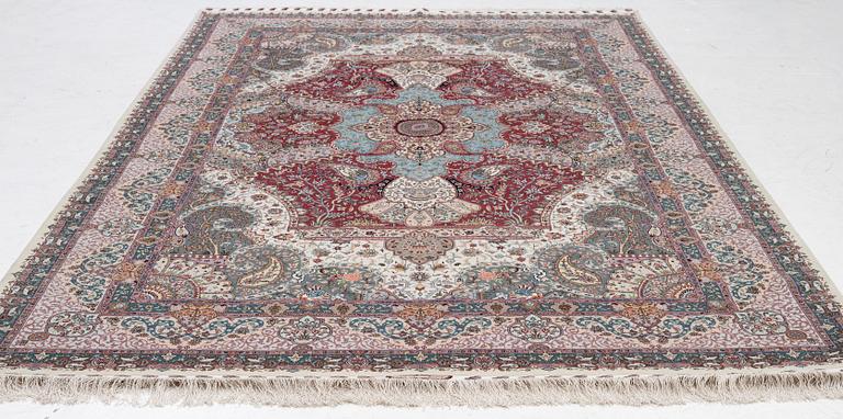 A Tabriz carpet, 210 x 195 cm. signed.