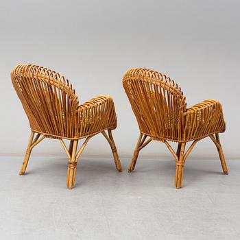 A pair of rattan armchairs, Emilio Paoli, via Vigna Nuova, 8, Firenze, Italy, second half of the 20th century. Signed.