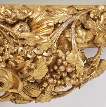 A presumably Dutch Louis XIV carved giltwood frame with mirror glass, in the style of Jean Le Pautre, late 17th century.