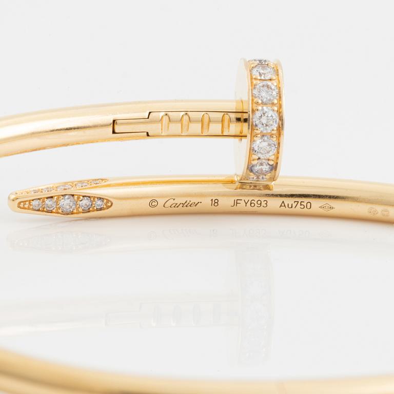 A Cartier "Juste un Clou" bracelet in 18K gold set with round brilliant-cut diamonds.