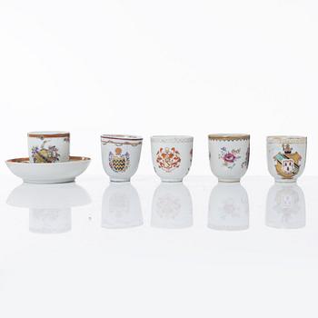 A group of four Chinese armorial cups, one cup with saucer, Qing dynasty, 18th century.