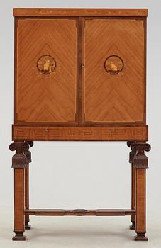 An Erik Matsson marquetry cabinet on stand, Carl Johansson Möblering AB, Stockholm 1932.