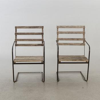 A pair of garden chairs.