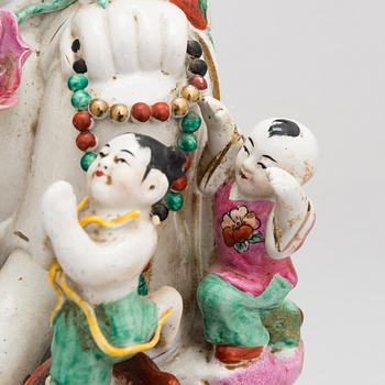 A Chinese porcelain laughing buddha with children, the 20th century.