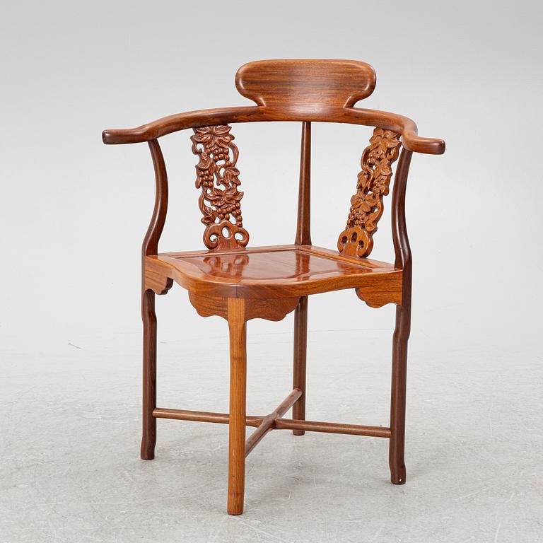 A Chinese hardwood corner armchair, 1900s.