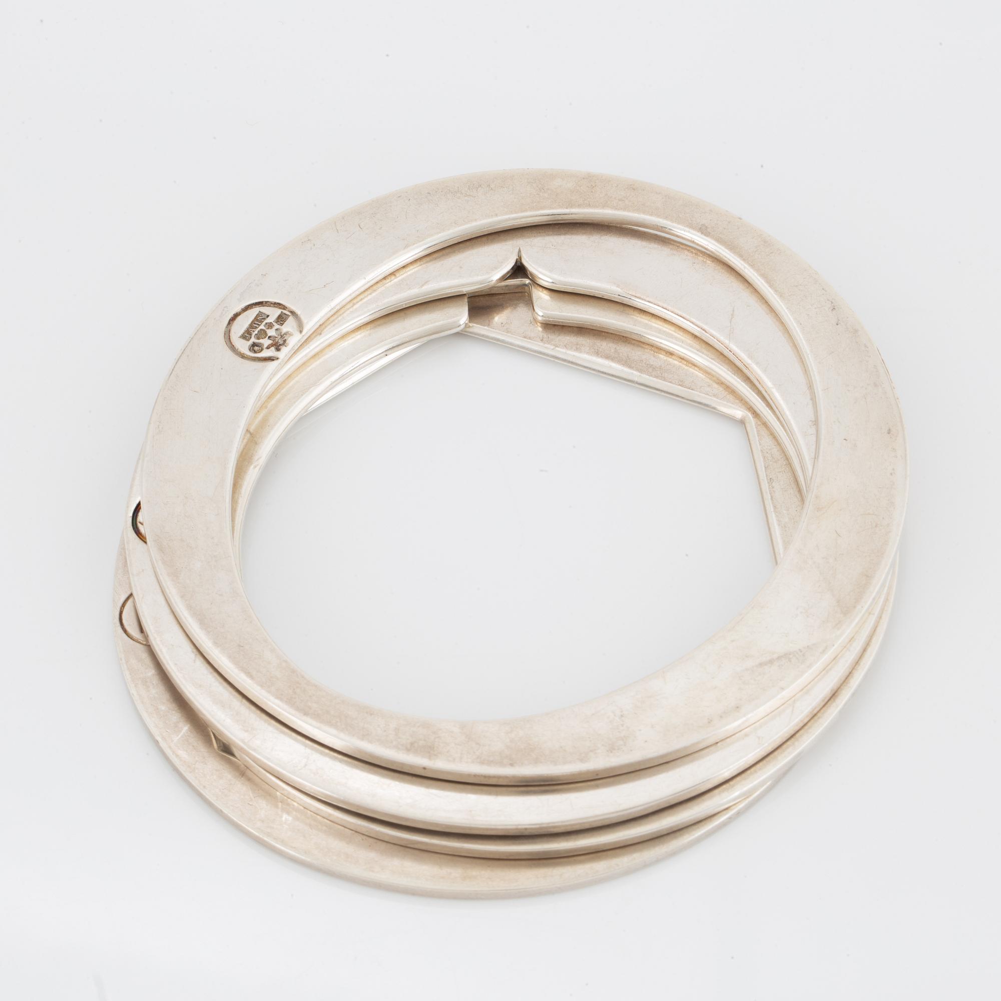 4 silver bangles.