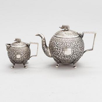 A silver teapot and milk jug, around the turn of the 20th century.