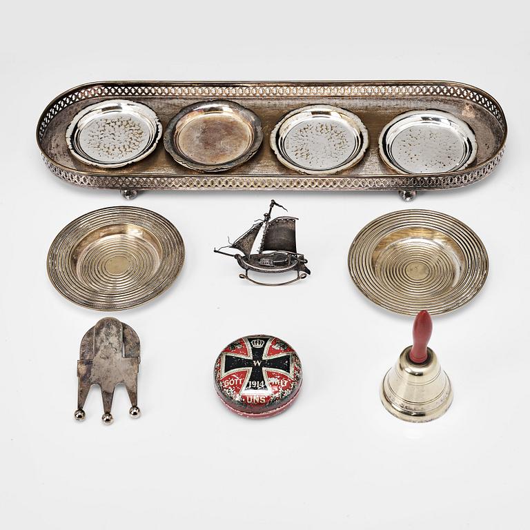 A table-bell, tray, ash-trays, snuff box, clip and a miniature-ship, silver plated and brass. 20th century.