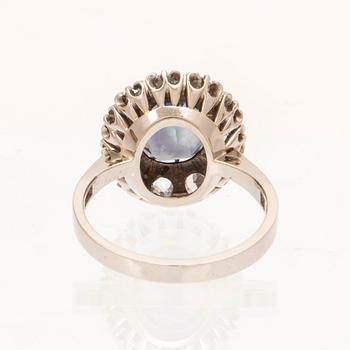 An 18K white gold ring with a colour change synthetic purple sapphire and brilliant and old cut diamonds.
