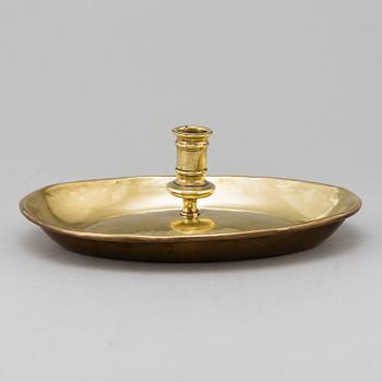 An 18th century brass candlestick.