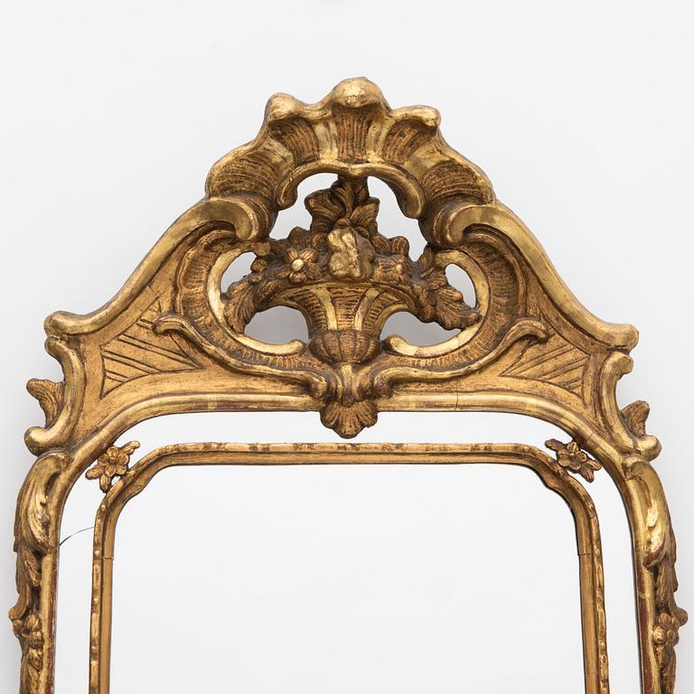 A Rococo style mirror, circa 1900.