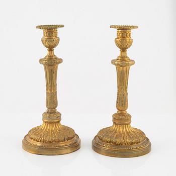 A pair of bronze candle sticks, 20th Century.