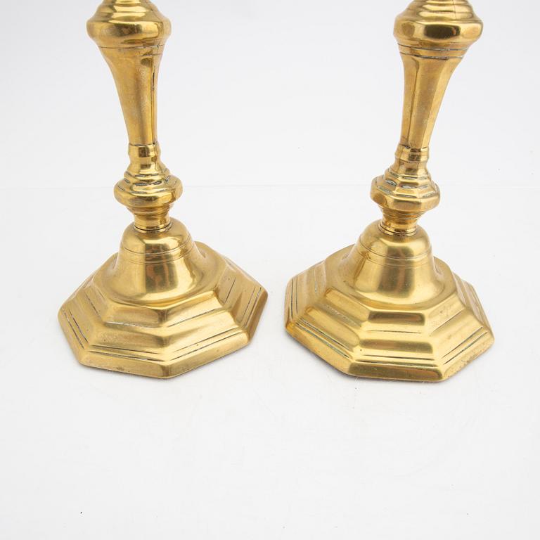 A pair of 18th century brass candle sticks.