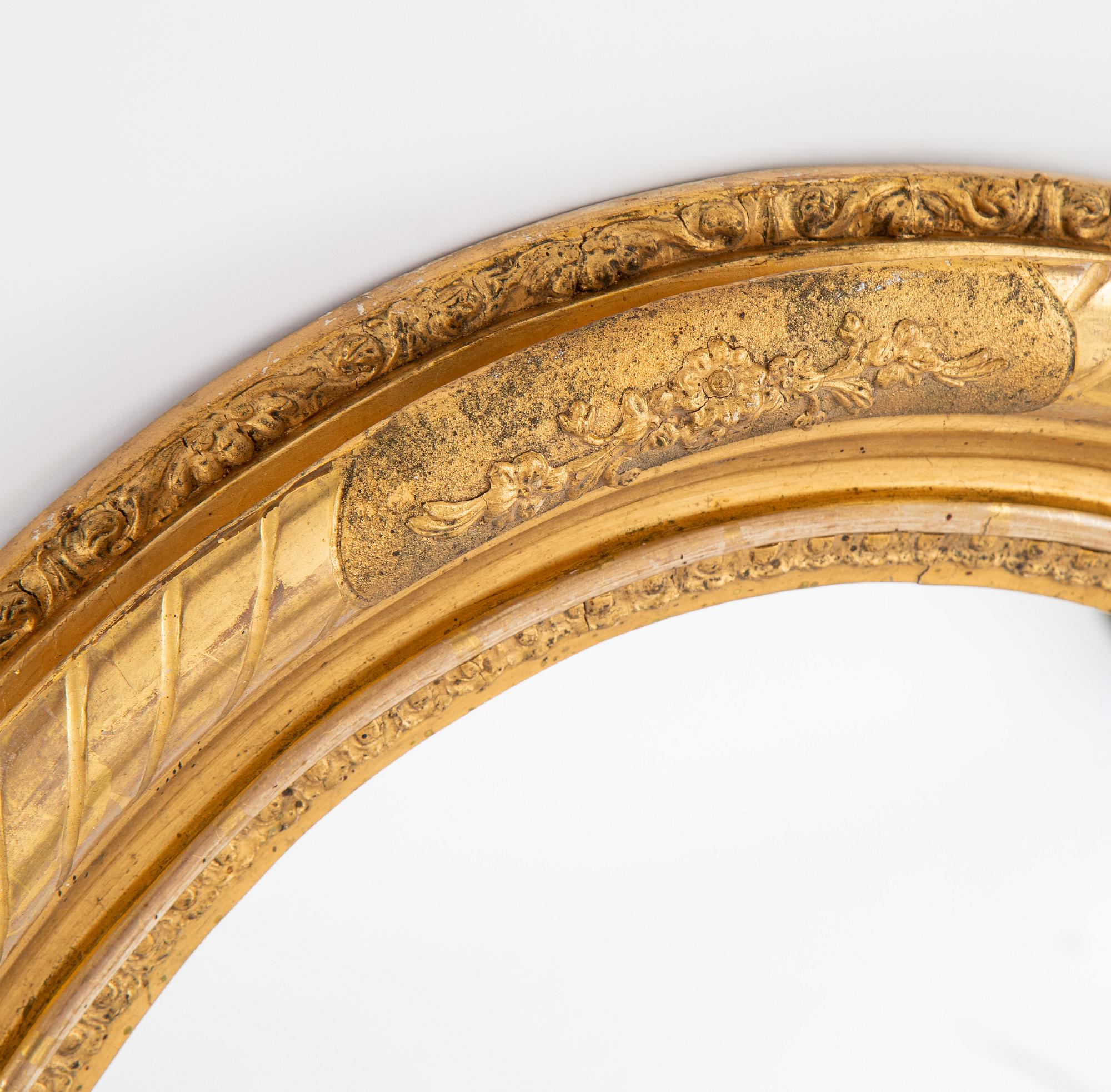 An oval mirror from around the year 1900.