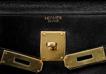 A black leather "Kelly" handbag by Hermès, prob from the 1960s.