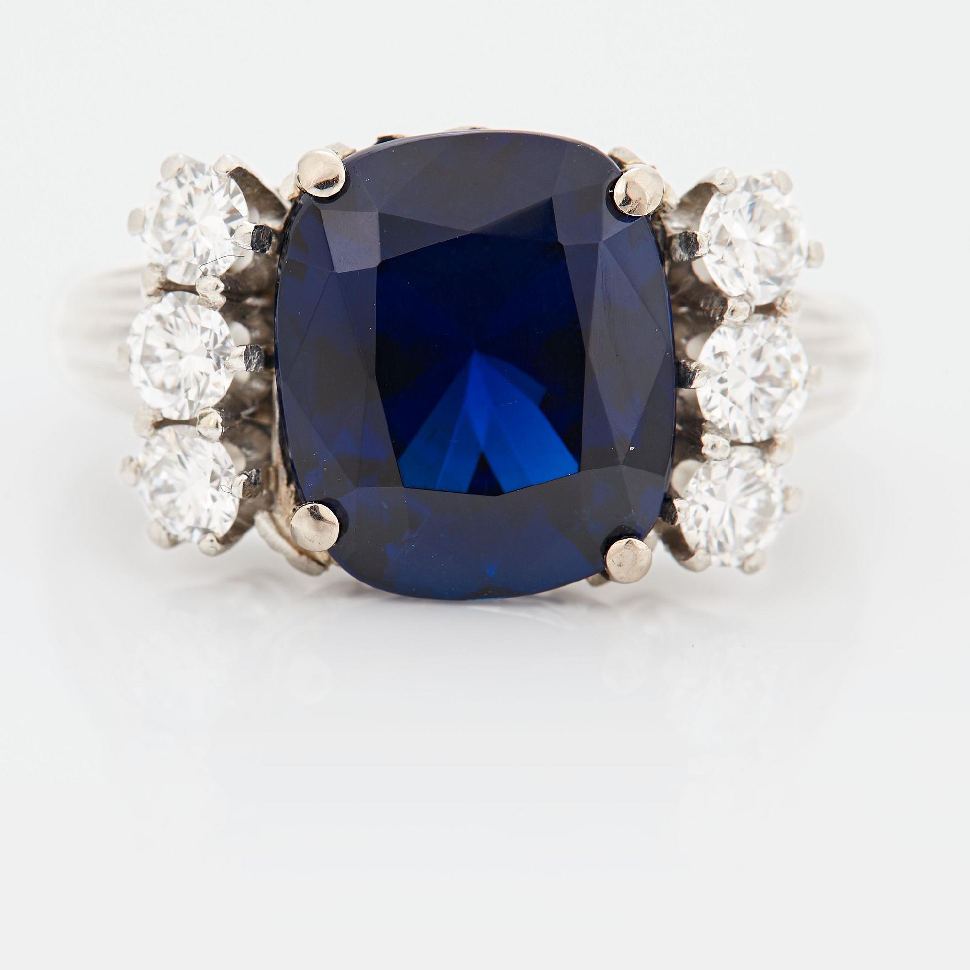 A RING set with a faceted sapphire.