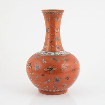 A Chinese coral read ground butterfly vase, 20th century.